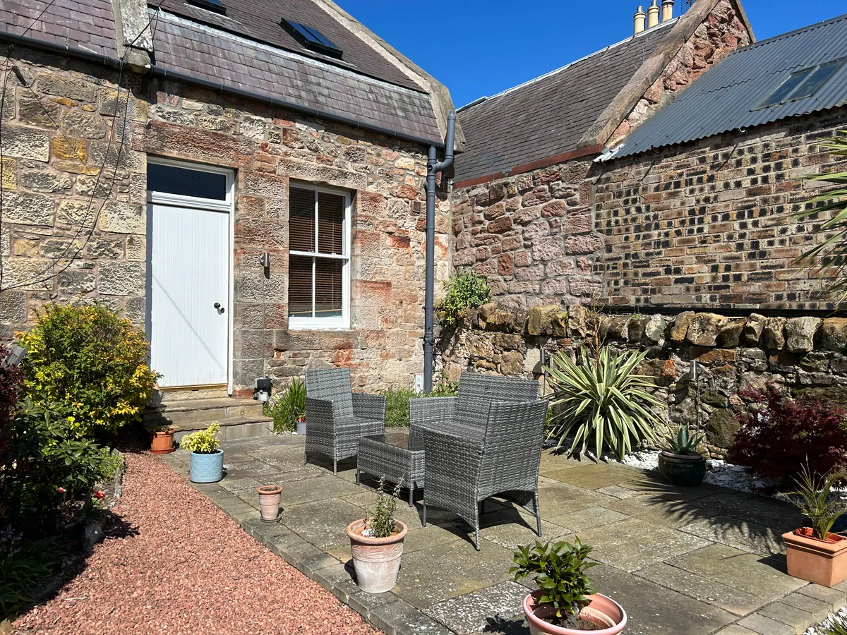 Private furnished patio with outdoor heater and south-facing garden